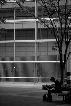 Businessman working on a bench outdoors