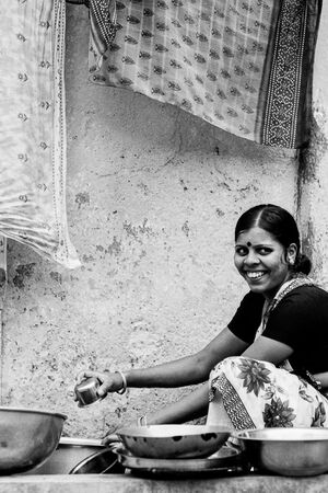 Woman working in the water place by the wayside