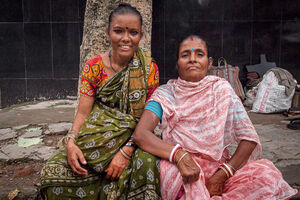 Two women wearing saree