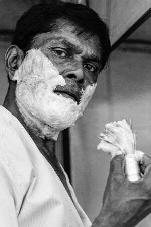 Man putting shaving cream on face