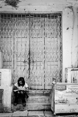 Girl studying by roadside