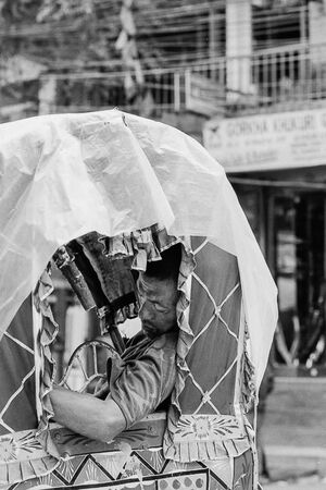 Exhausted rickshaw wallah