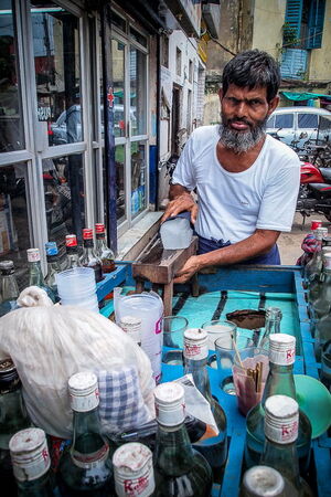 Man at a food stall selling juice shaving ice