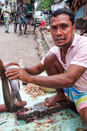 Man cutting fish with a unique knife