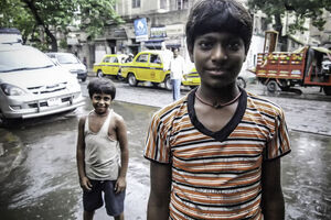 Two boys standing by roadside