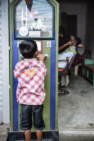 Boy looking at weighing scale