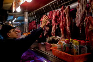 man extending his arm in butcher