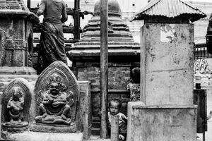 Boy playing among Buddha images