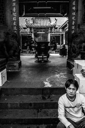 Man sitting at entrance of temple