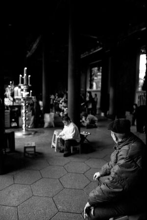 Old man sitting in precinct