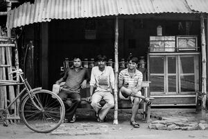 Men relaxing on bench in cafe