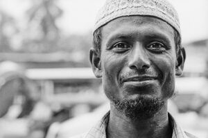 Smiling man wearing taqiyah