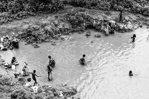 People standing in Mahananda River