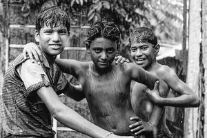 Boys standing in the rain