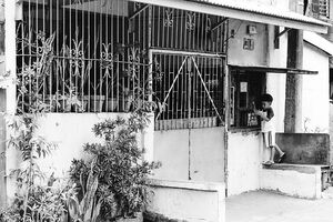Boy beside iron bars