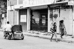 Two women walking sidewalk