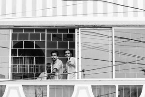 Three men by window