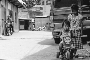 Little girl riding tricycle