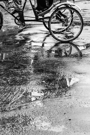Cycle rickshaw on wet ground