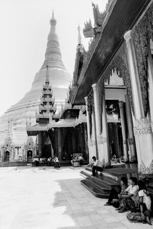 People resting near pagoda in Shwedagon Paya
