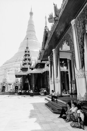 People resting near pagoda in Shwedagon Paya