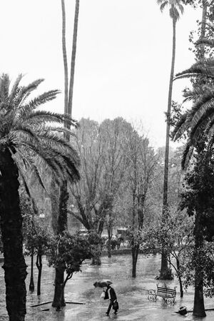 Man walking in hard rain