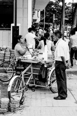 Man in front of food stall