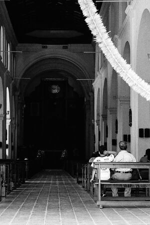 Father and son sitting in church