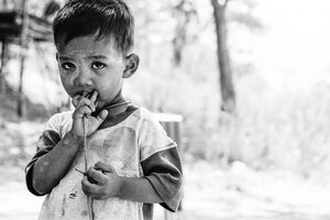 Little boy holding spinning top
