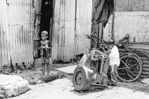 Two boys standing in corner of street