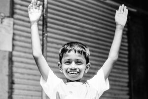 Boy raising arms up