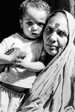 Older woman and little girl putting Bindi
