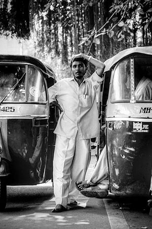 Man between auto rickshaws