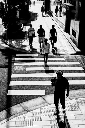 Silhouettes on sidewalk