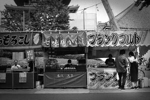 Young couple standing in front of food stall