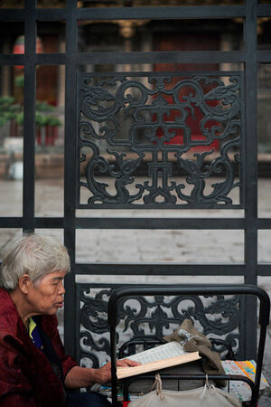 Old woman reading sutra