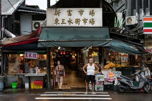 Man standing at the entrance of Xinfu Market