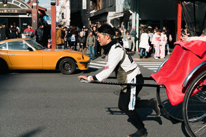 Rickshaw man and supercar