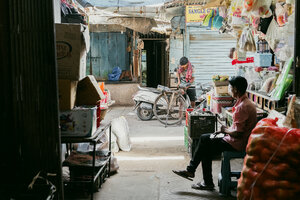 Man sitting at the entrance to the market