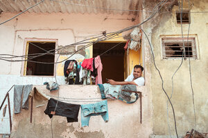 Man relaxing next to laundry