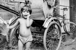 Little girl beside cycle rickshaw