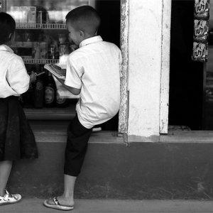 Girl and boy standing together in storefront