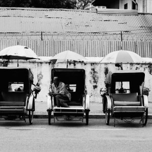 Many trishaws parked by roadside