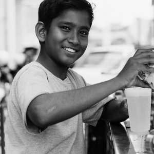 Boy making fresh juice happily