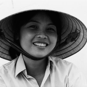 Young woman smiling under conical hat