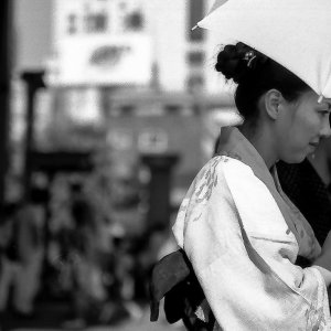 Young woman in Kimono coming out of Senso-ji