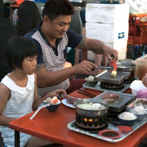 Father and daughter in night market