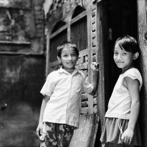 Boy and girl standing talking in lane