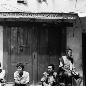 Men hanging out in front of closed store