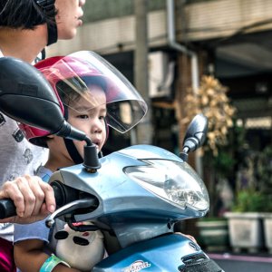 Kid on motorbike with mother